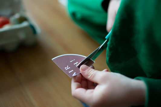 child learning to use scissors
