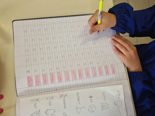 Child practicing handwriting letters in a notebook with a pencil
