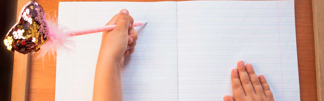 child writing left-handed