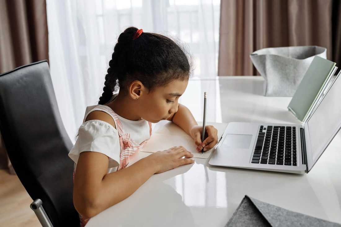Girl practicing handwriting at a desk