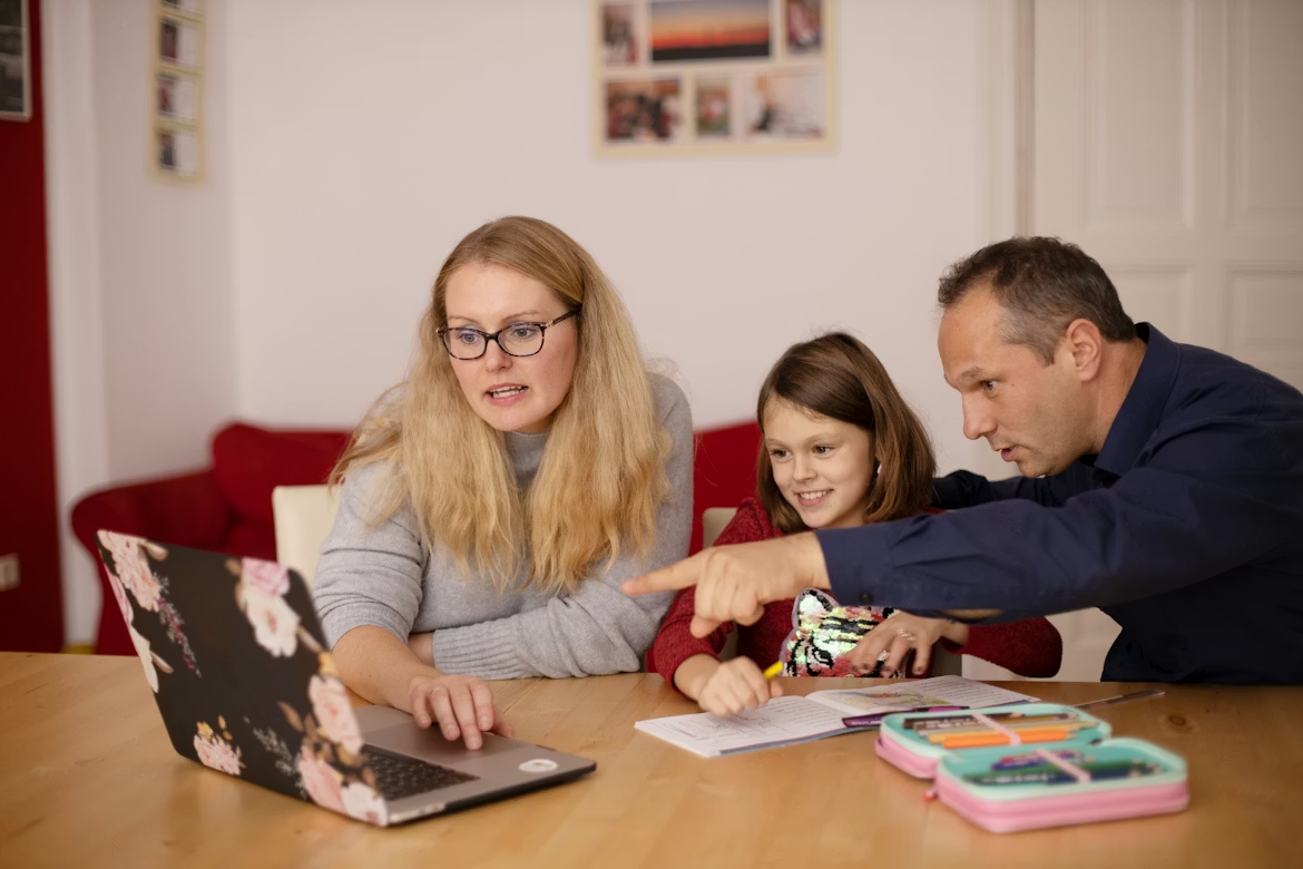 Parents teaching their child handwriting