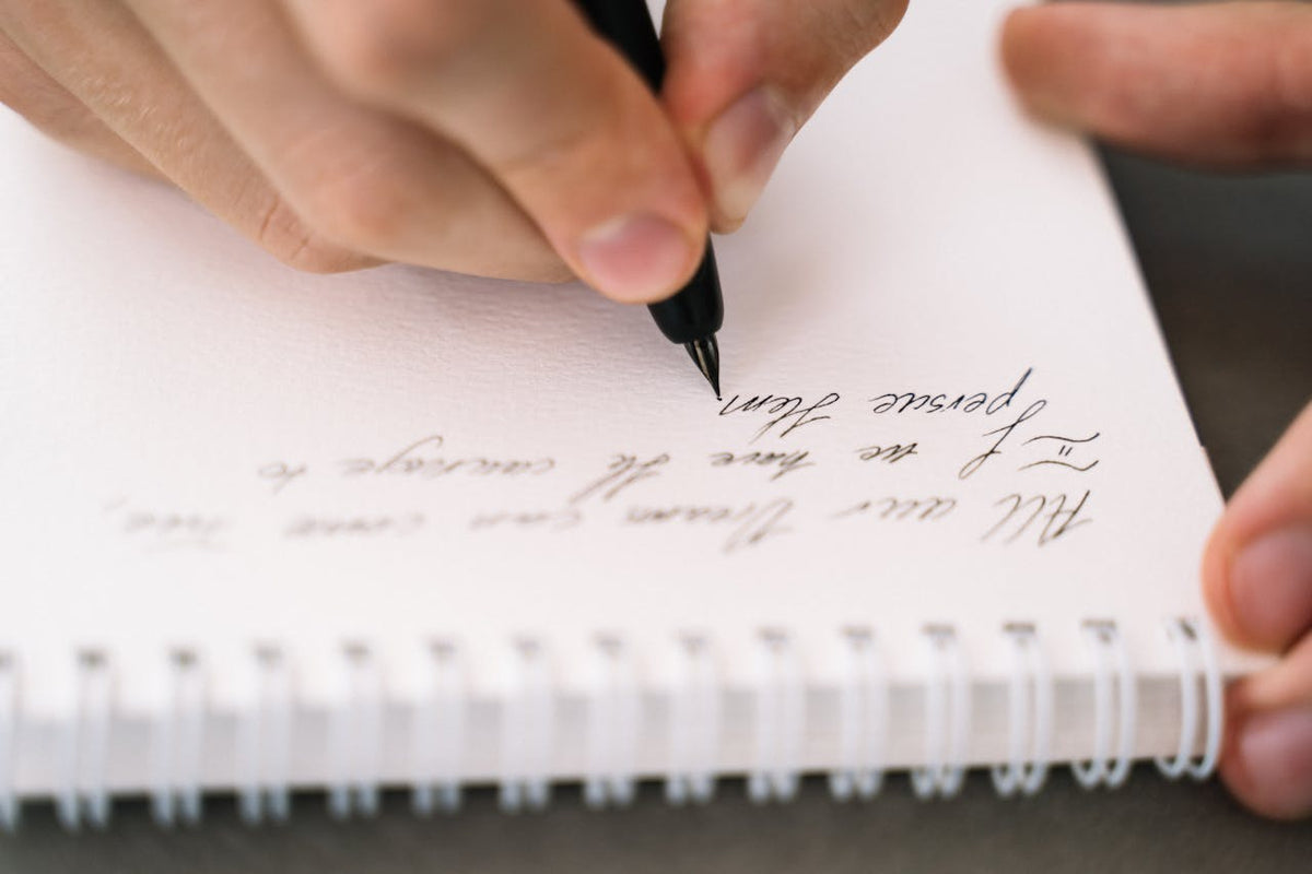 Person writing in cursive